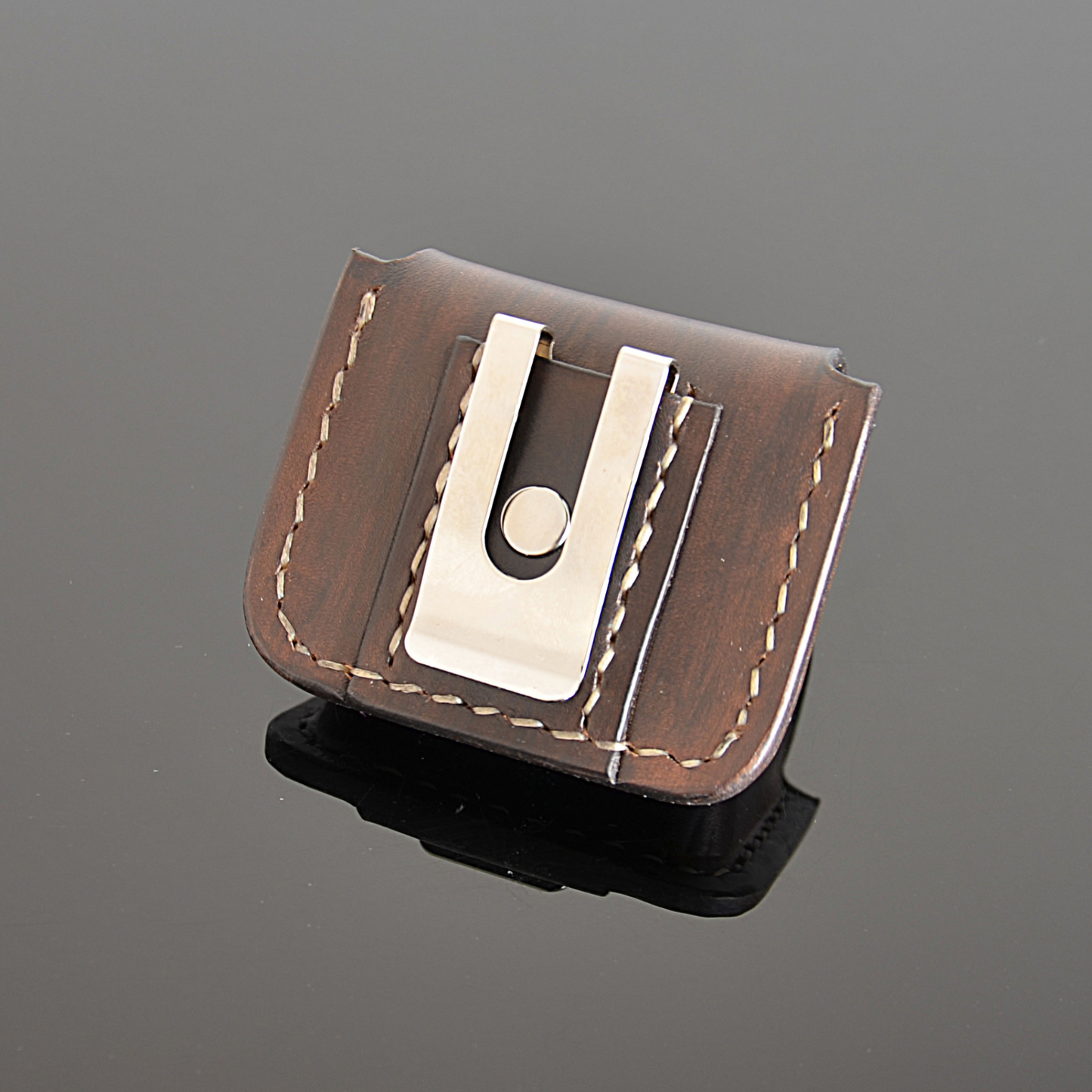 Back side of brown leather earbuds case showing clip and precise stitching