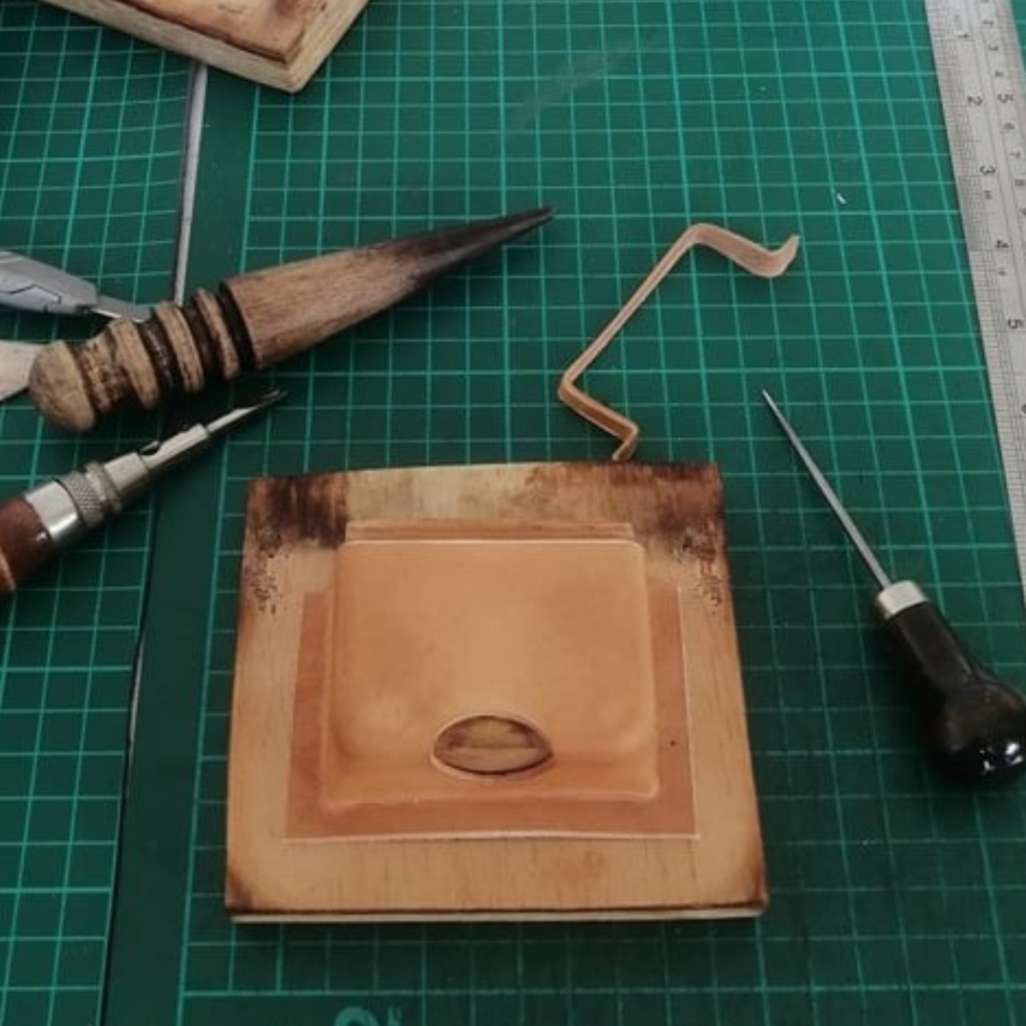 Wet-molded leather pouch on wooden pattern ready for earbuds pouch making by exodos copenhagen