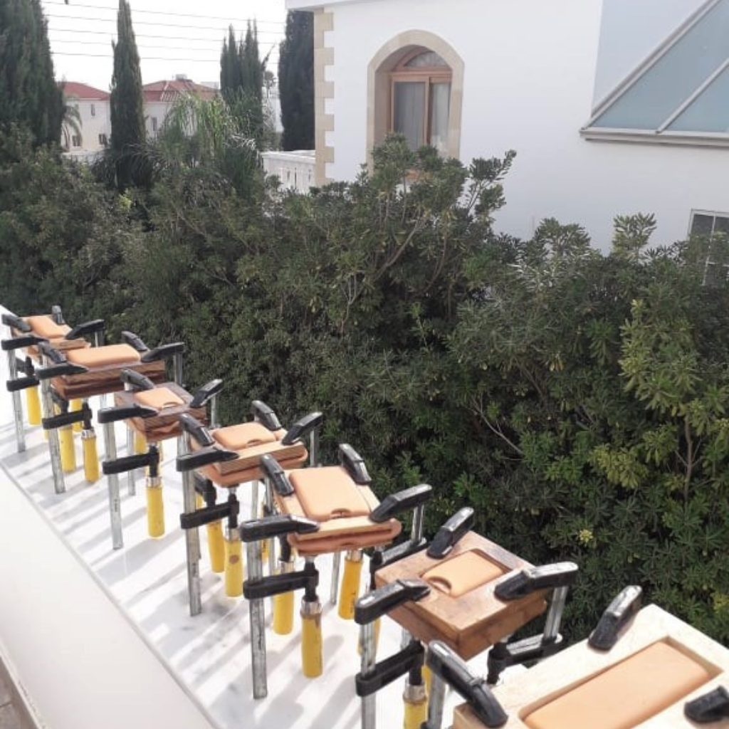 Wet-molded leather pouches drying on wooden molds outside EXODOS Copenhagen workshop